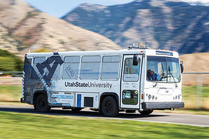 Utah State University Electric Bus driving on road near a canyon in the mountains