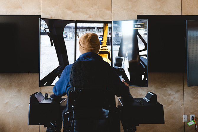 Man using advanced construction equipment simulation
