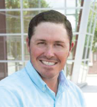 Smiling man in blue shirt