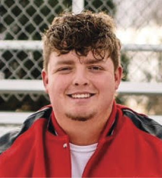 Headshot of man in red windbreaker