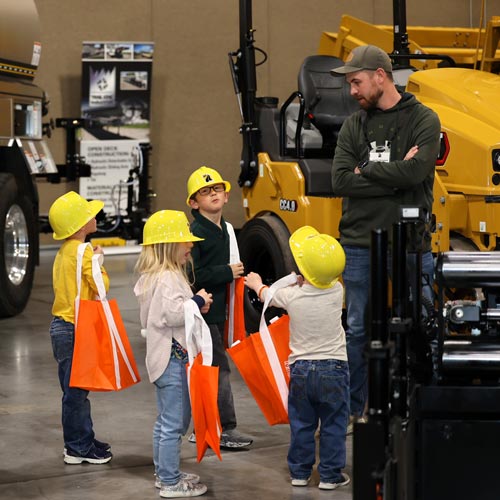 Man with four children in hardhats