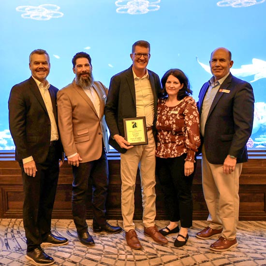 Five people with plaque at aquarium