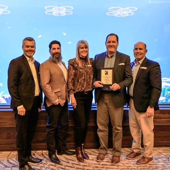 Five people with plaque at aquarium