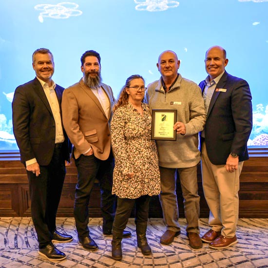Five people with plaque at aquarium